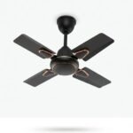 High-resolution studio product shot of a modern, compact 4-blade ceiling fan centered against a clean, plain white background. The fan features a sleek matte black finish on the blades, motor housing, and downrod, accentuated with polished copper/rose gold trim rings around the motor base and blade mounts. No text or logos are visible.