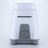 A clean, front-facing studio photograph of a modern electric mixer grinder base presented against a solid, light-grey background. The appliance features a glossy white tiered polymer upper body resting on a smooth grey molded base equipped with non-slip rubber feet.